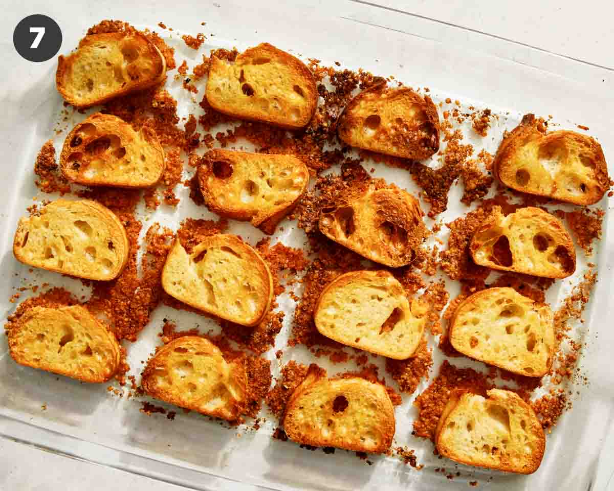 Parmesan crusted crostini in a baking dish ready to be served. 