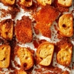 Parmesan crusted crostini in a baking dish.