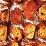 Parmesan crusted crostini in a baking dish.