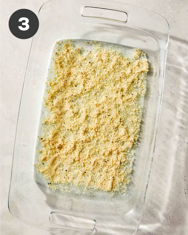 A parmesan mixture sprinkled all over the bottom of a baking dish.
