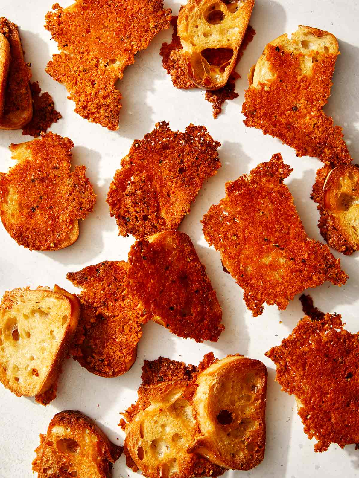 A bunch of parmesan crusted crostini. 