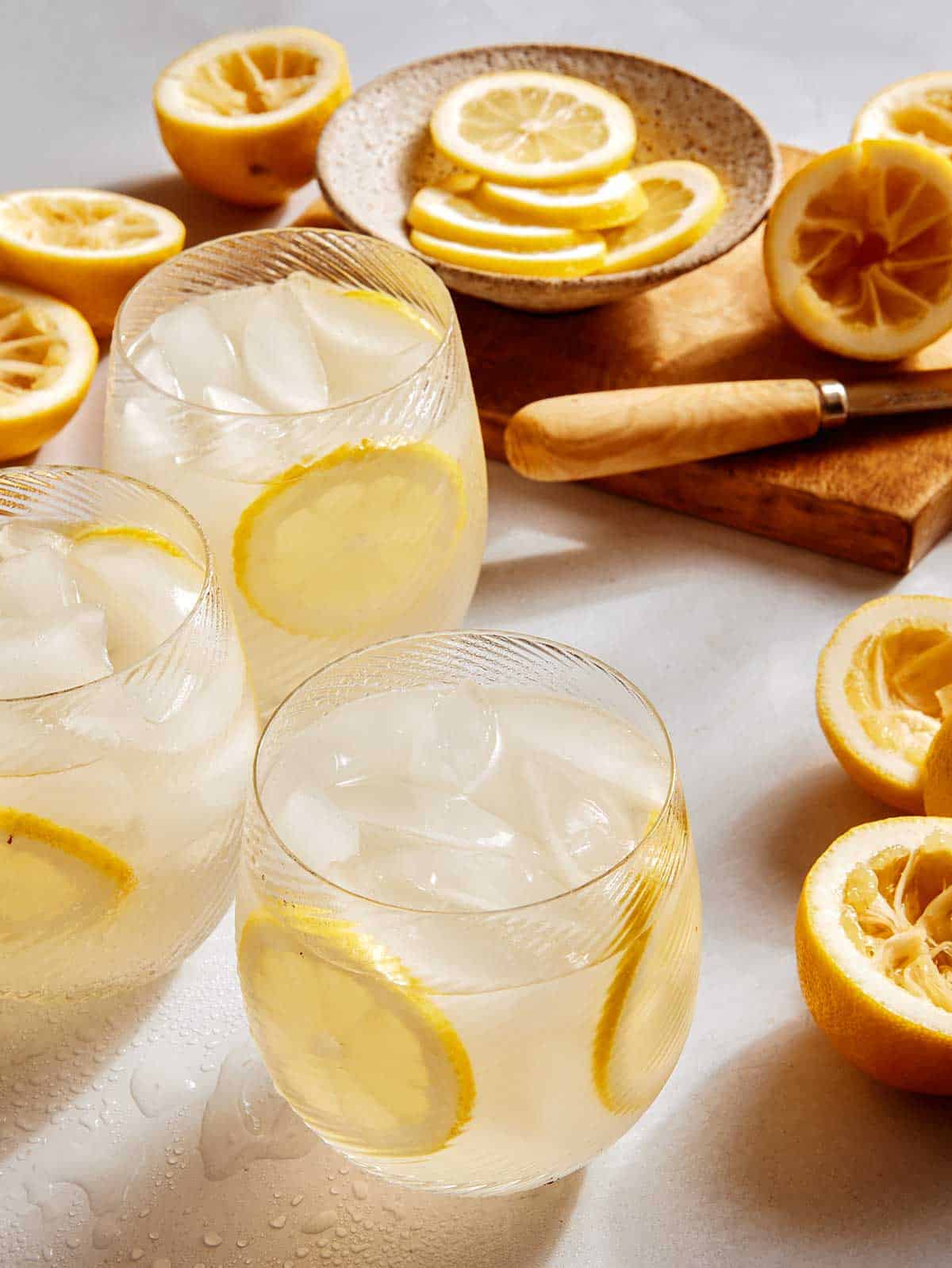 Classic lemonade recipe in glasses garnished with lemon wheels. 