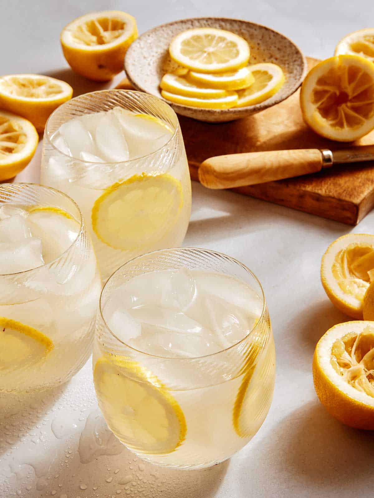 Classic lemonade recipe in glasses garnished with lemon wheels.