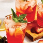 Strawberry lemonade with a mint garnish in glasses.