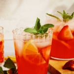 Strawberry lemonade with a mint garnish in glasses.