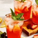 Strawberry lemonade with a mint garnish in glasses.
