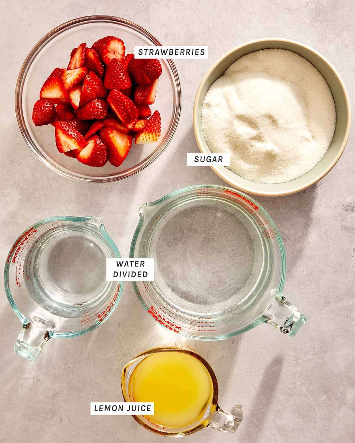 Strawberry lemonade ingredients on a kitchen counter. 