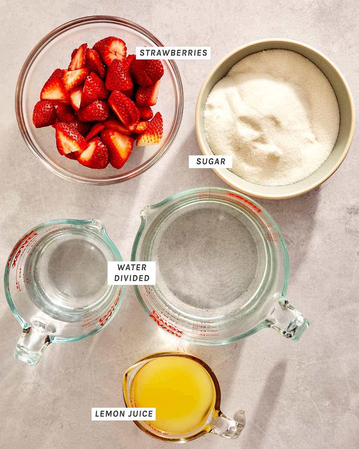 Strawberry lemonade ingredients on a kitchen counter.