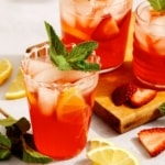 Strawberry lemonade with a mint garnish in glasses.