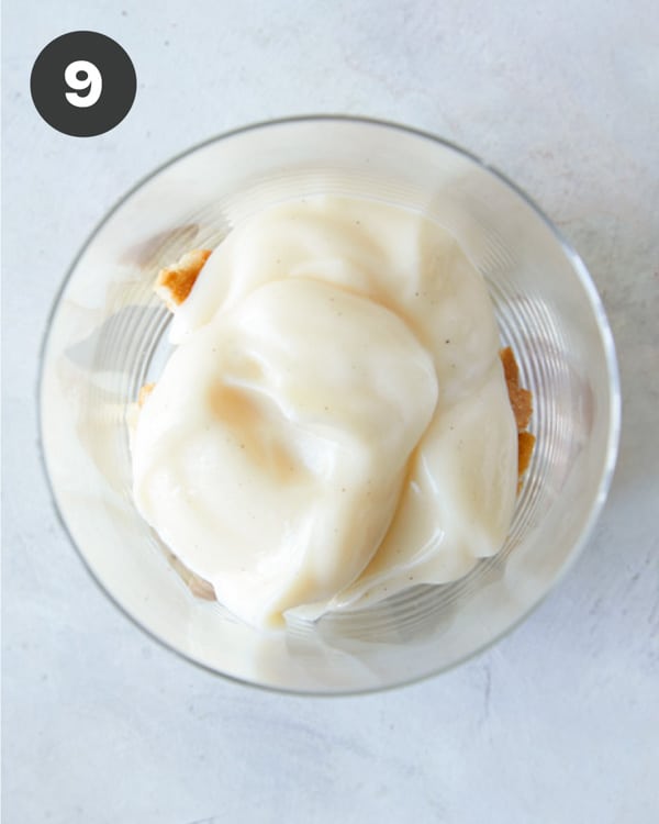 Layering banana pudding ingredients in a cup to make banana pudding. 