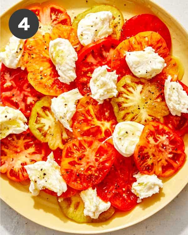 Making a caprese salad on a platter. 