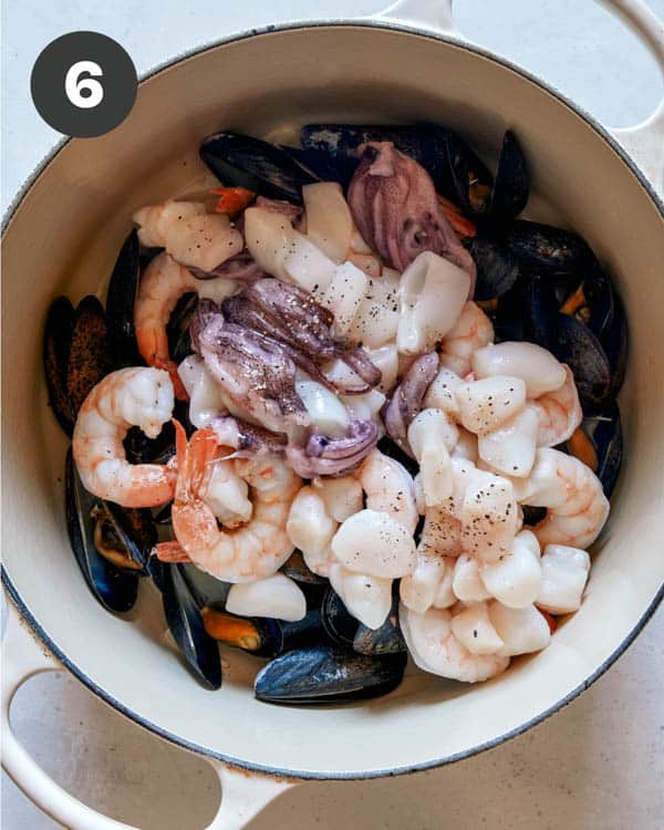 Seafood being cooked in a pot to make frutti di mare. 