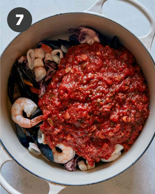 Frutti di mare in a pot about to be stirred together. 