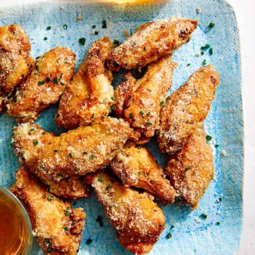 Parmesan dusted chicken wings on a platter.