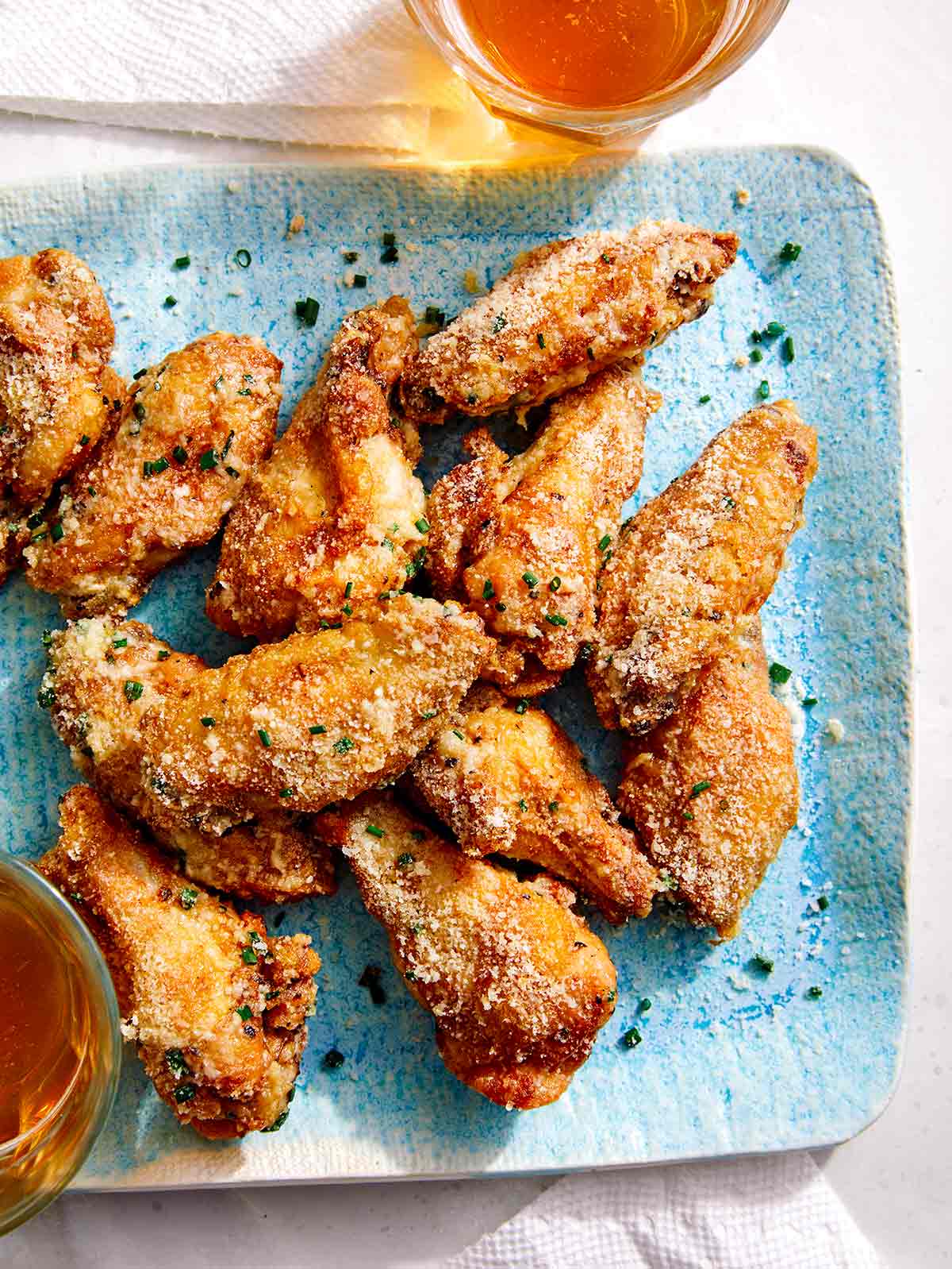 Parmesan dusted chicken wings on a platter. 