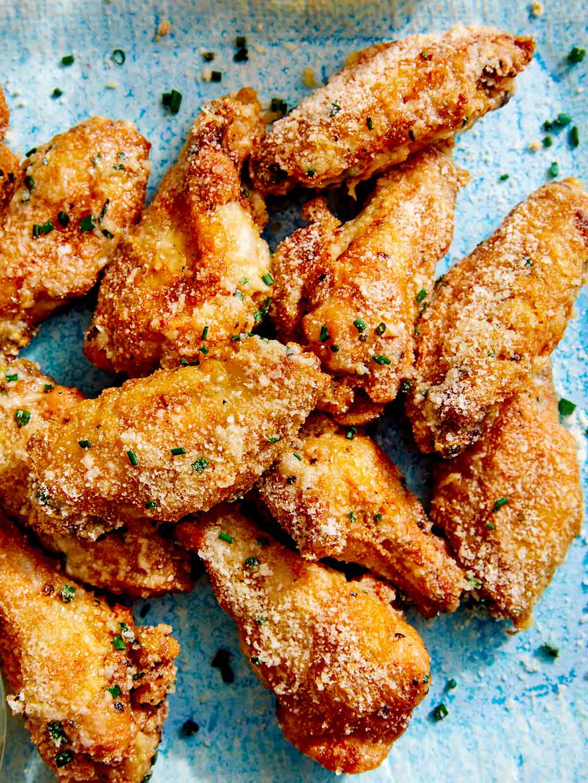 Parmesan chicken wings made in the air fryer on a platter. 