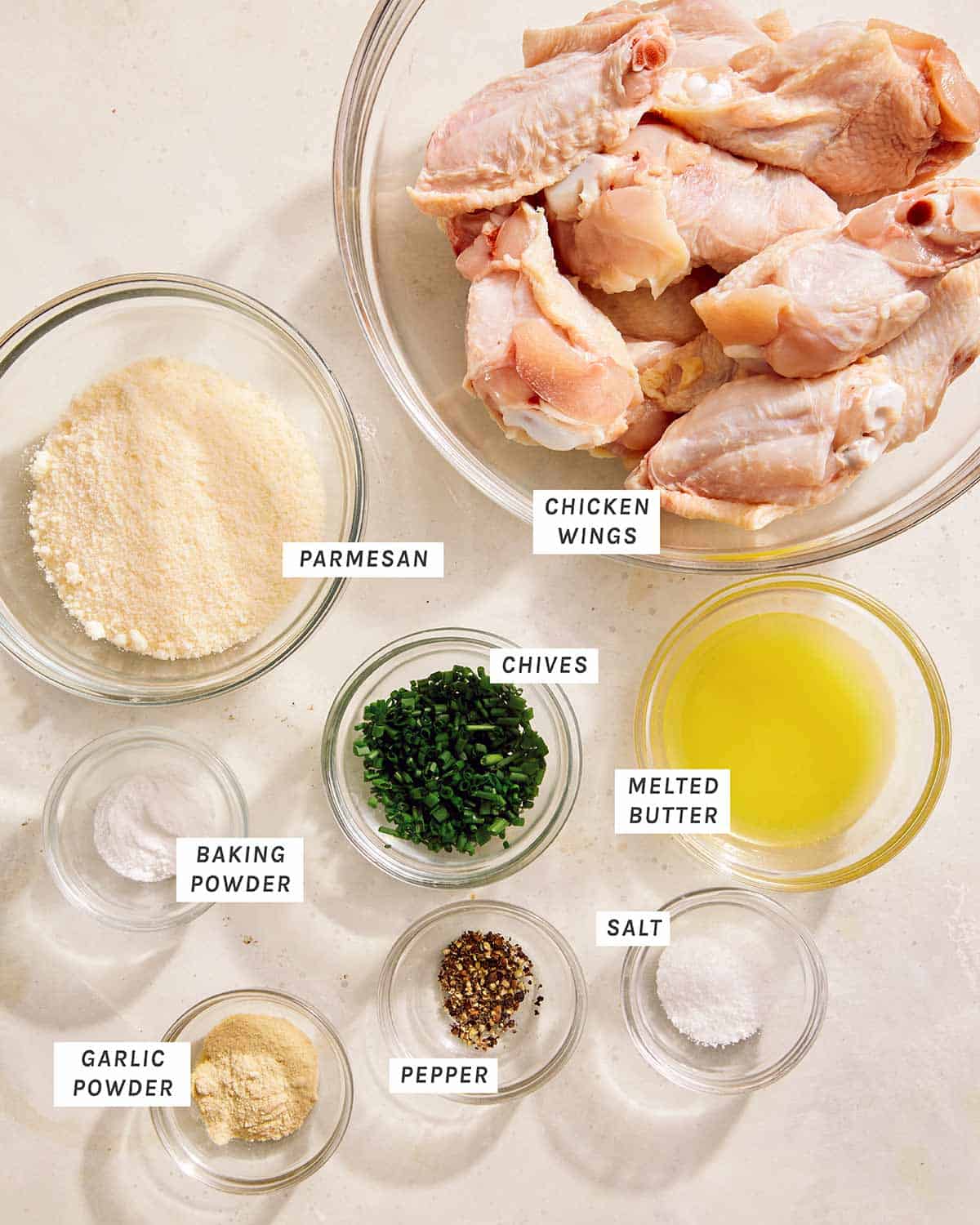 Parmesan chicken wings ingredients on a kitchen counter. 