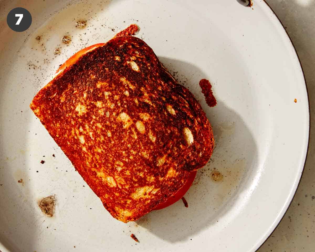 A tuna melt sandwich being cooked in a skillet. 