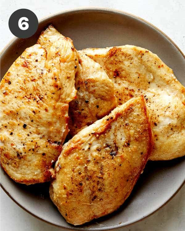 Seared chicken resting on a plate. 