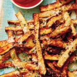 Air fryer french fries on a platter with ketchup and mayo.