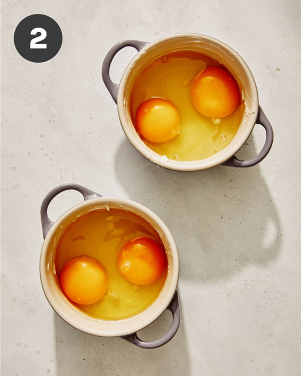 Raw eggs in cocotte ready to be baked. 