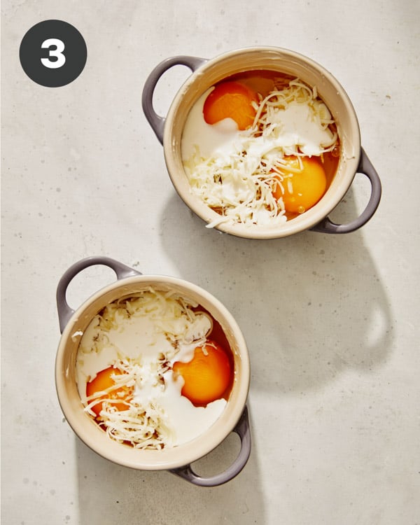 Eggs in cocotte with cheese and cream poured in.