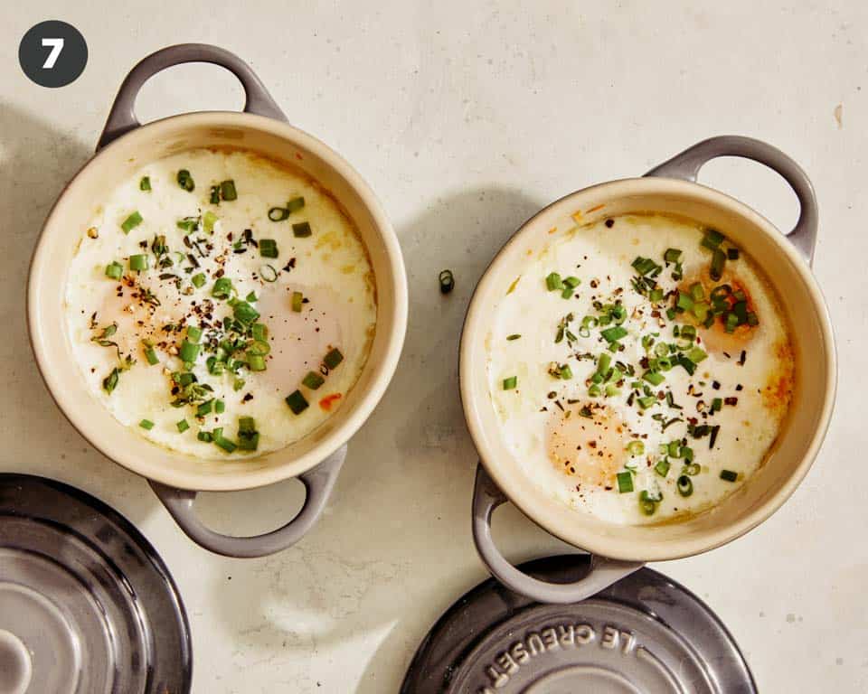 Baked eggs in cocotte with fresh herbs. 