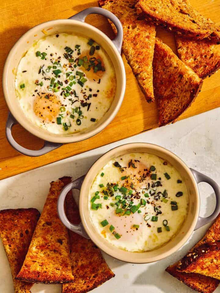 Baked eggs in cocotte with toast on the side.