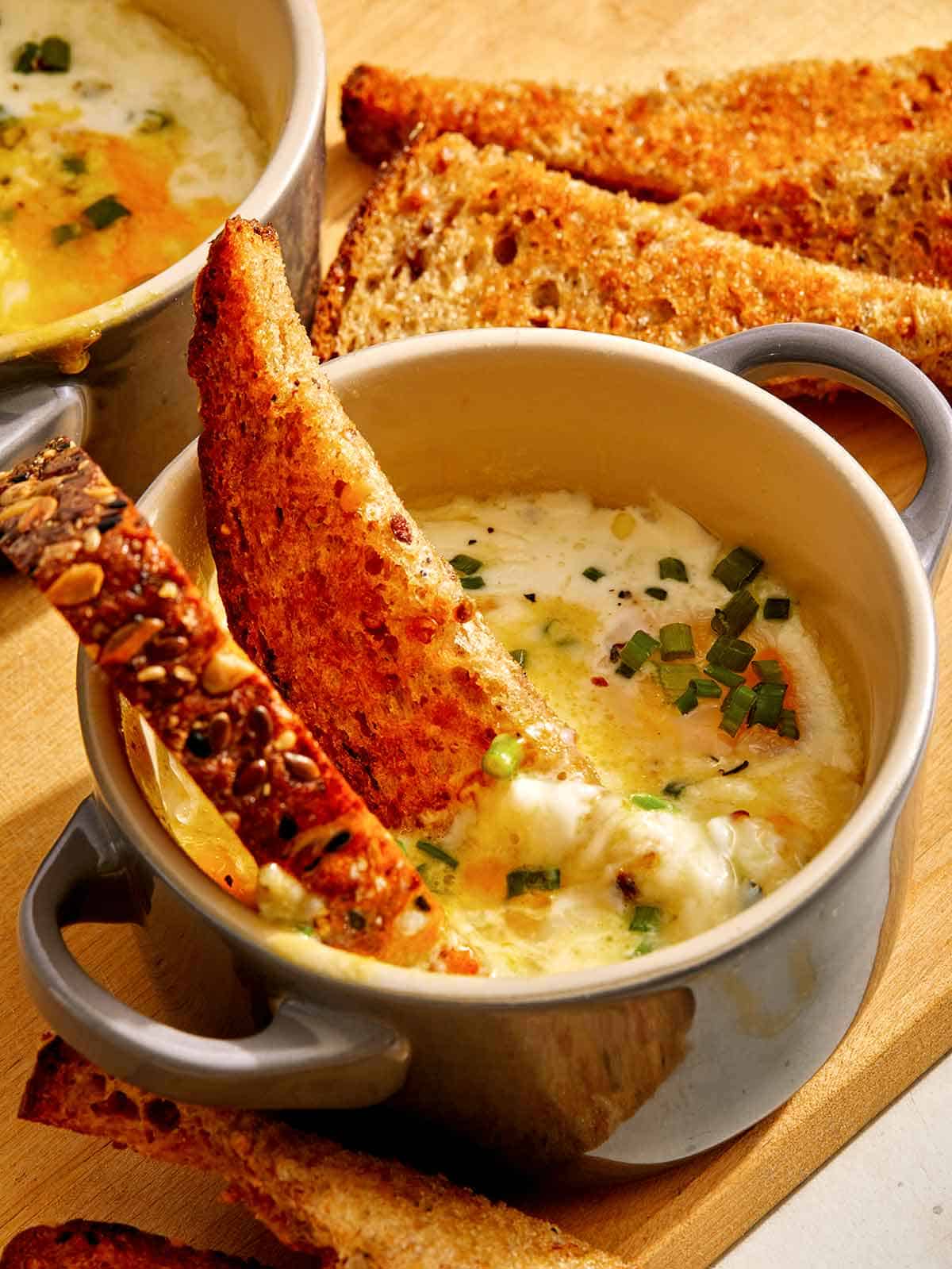 Baked eggs with toast dipped in. 