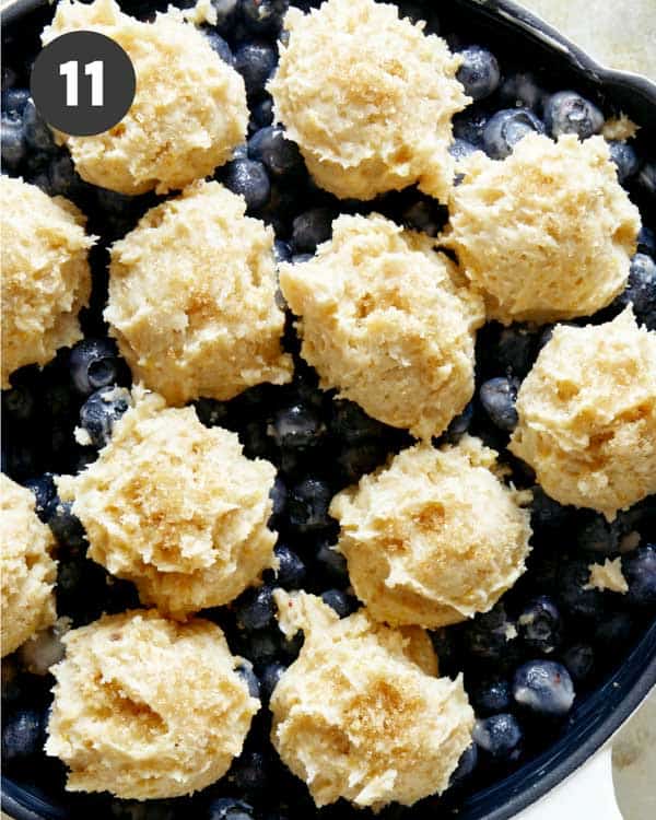 Blueberry cobbler in a skillet ready for the oven. 