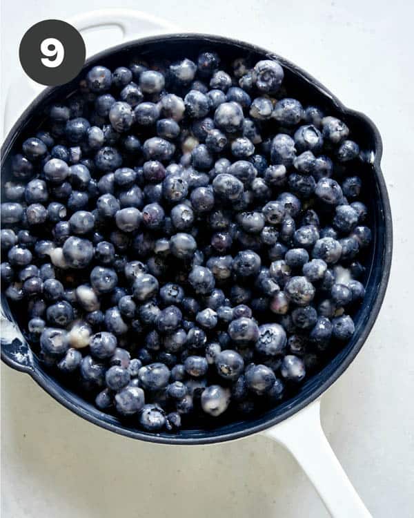 Blueberry cobbler filling in a skillet. 