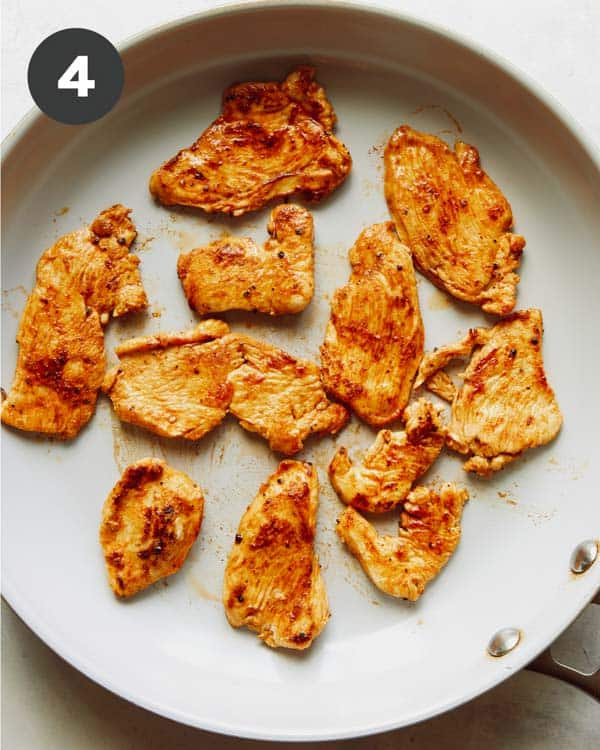 Chicken cooking in a skillet to make chicken fajitas. 