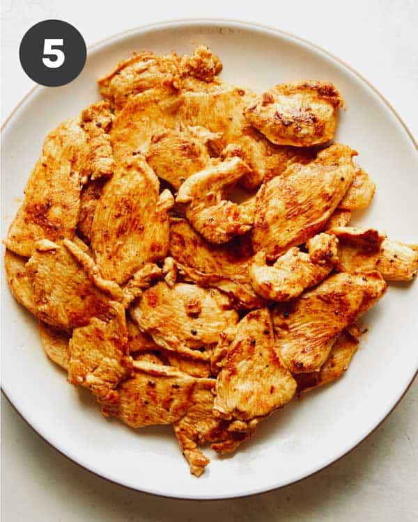 Chicken fajitas pieces resting on a plate.