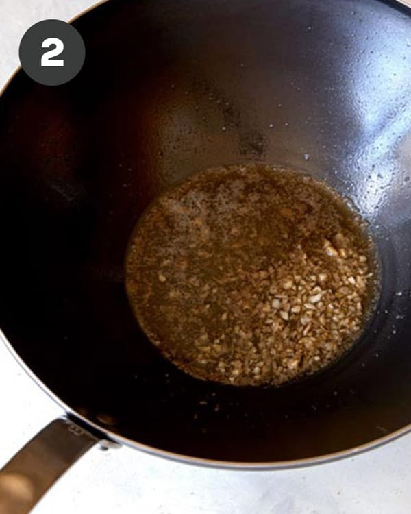 Garlic sautéd with butter in a wok.