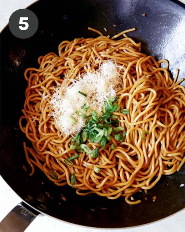 Cooked garlic noodles tossed with parmesan and green onions.