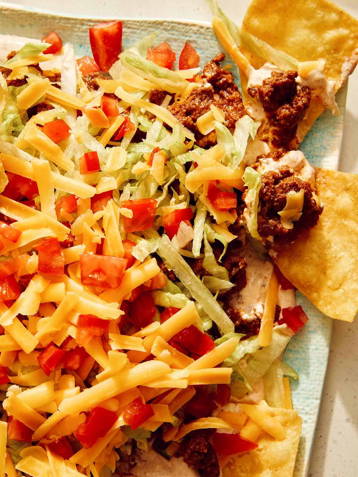 Taco dip with tortilla chips on the side.