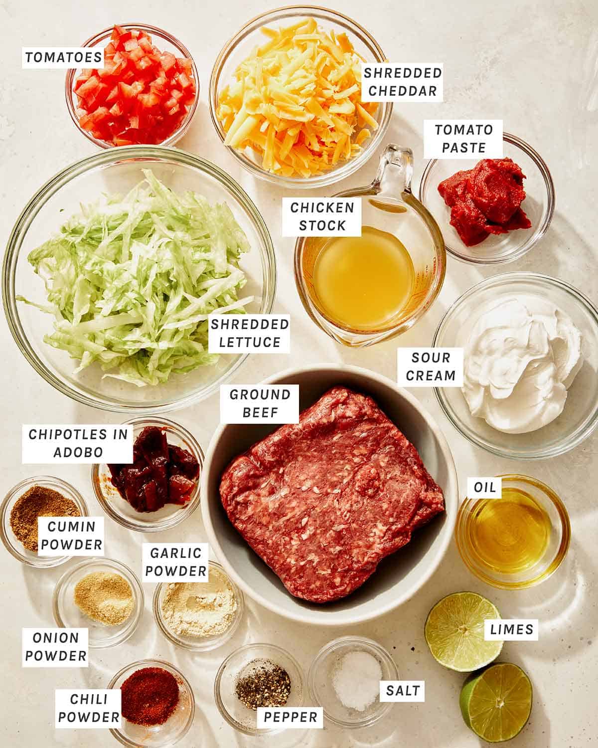 Taco dip ingredients all laid out on a kitchen counter to make the recipe.