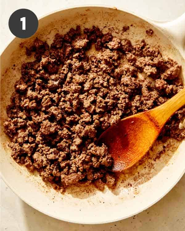Ground beef cooking in a skillet.