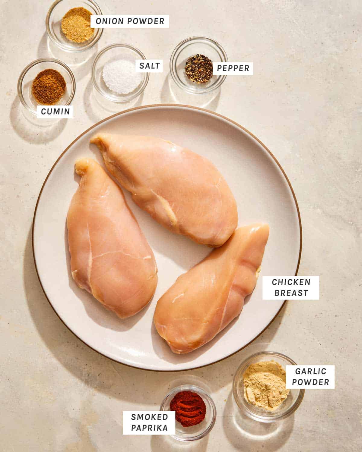 Air fryer chicken breast ingredients on a kitchen counter. 