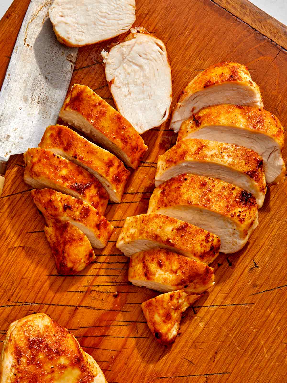Air fryer chicken breast recipe on a cutting board. 