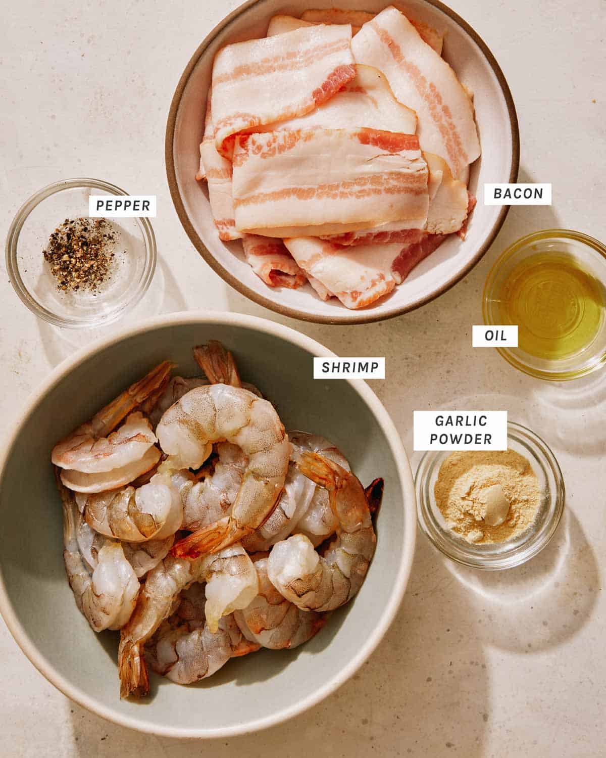 Bacon wrapped shrimp ingredients on a kitchen counter. 