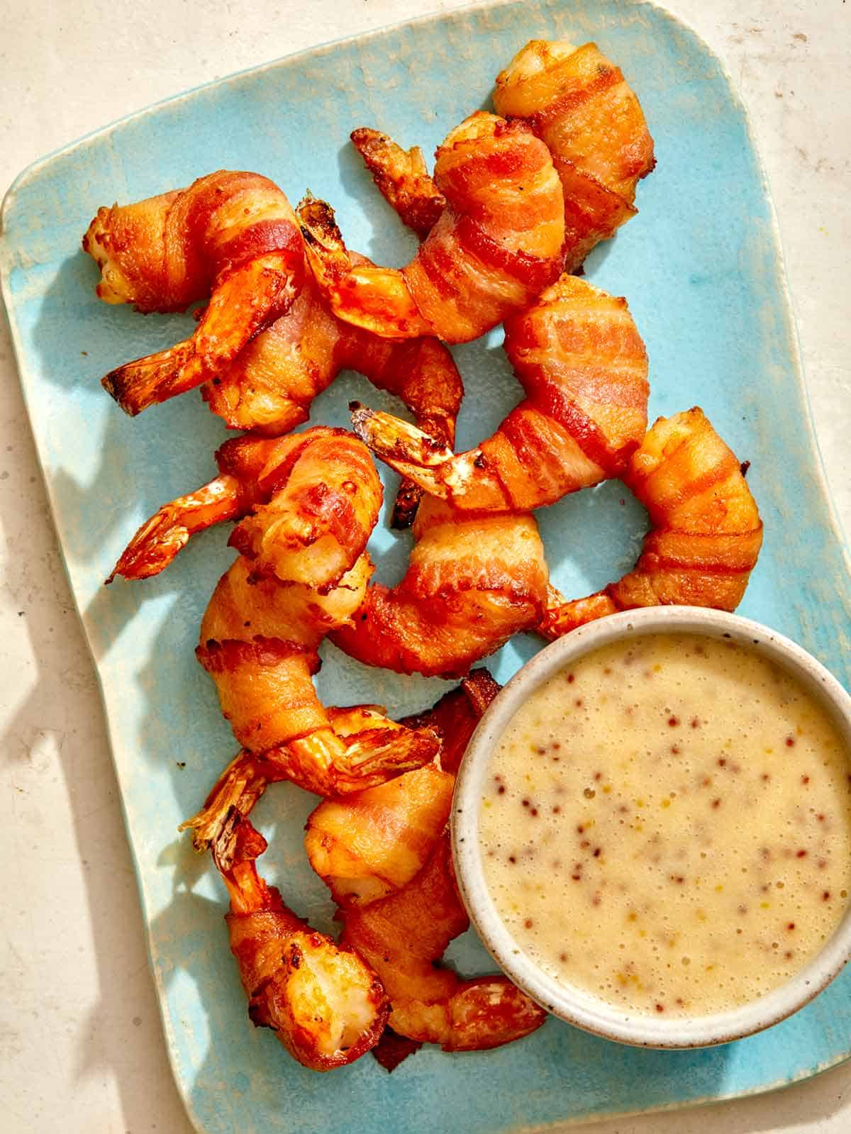 Air fryer bacon wrapped shrimp on a platter. 