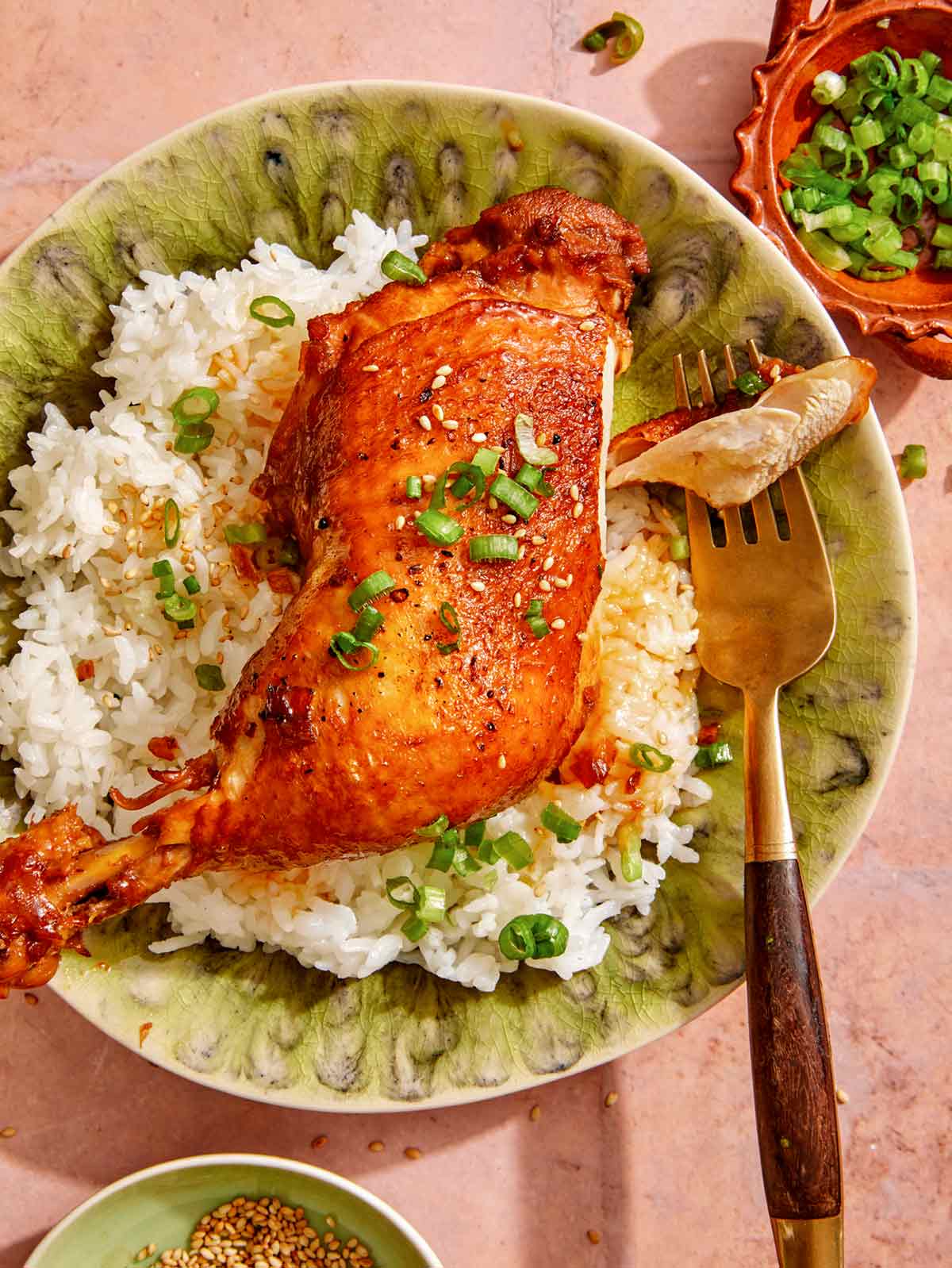 Braised garlic and ginger chicken with a piece on a fork. 