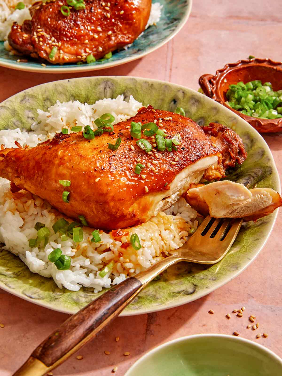 Garlic and ginger braised chicken with a piece of it on a fork. 