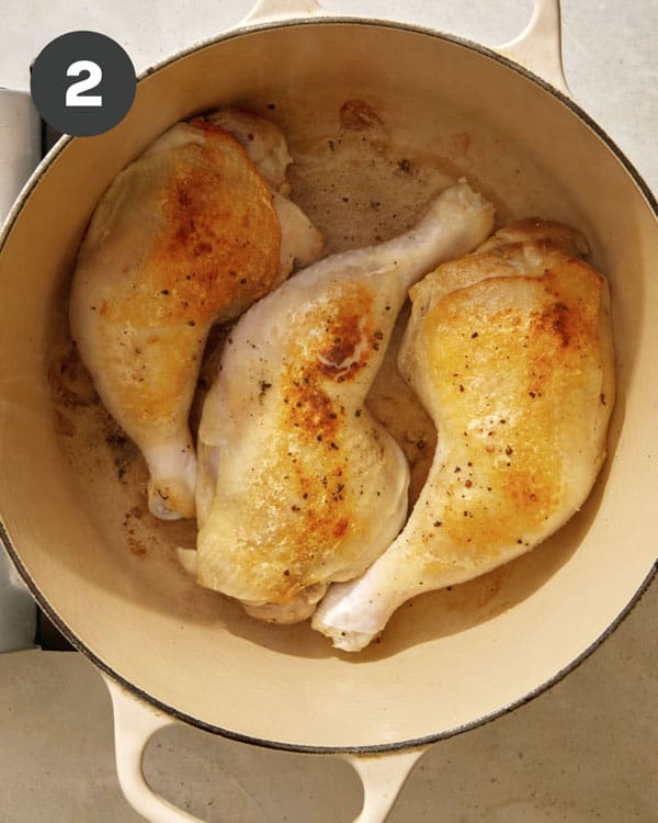 Chicken seared in a dutch oven.