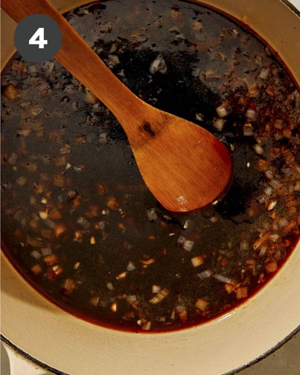 Garlic and ginger sauce being cooked in a pot for braised chicken.
