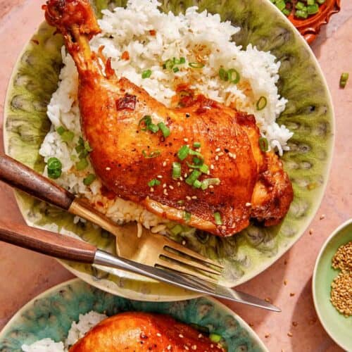 Garlic and ginger braised chicken recipe on two plates with rice.