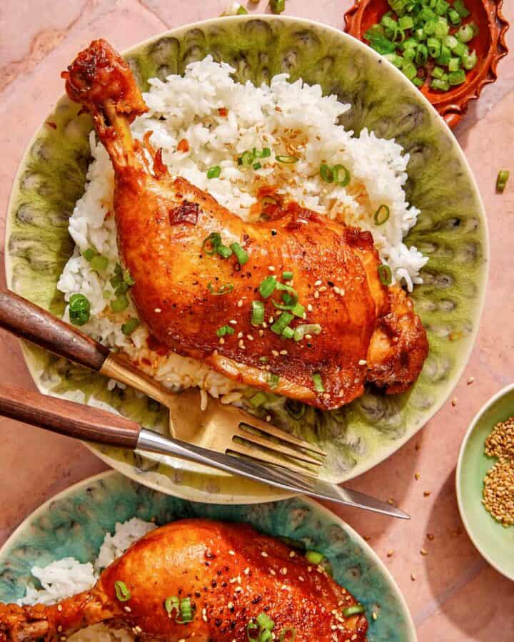 Garlic and ginger braised chicken recipe on two plates with rice.