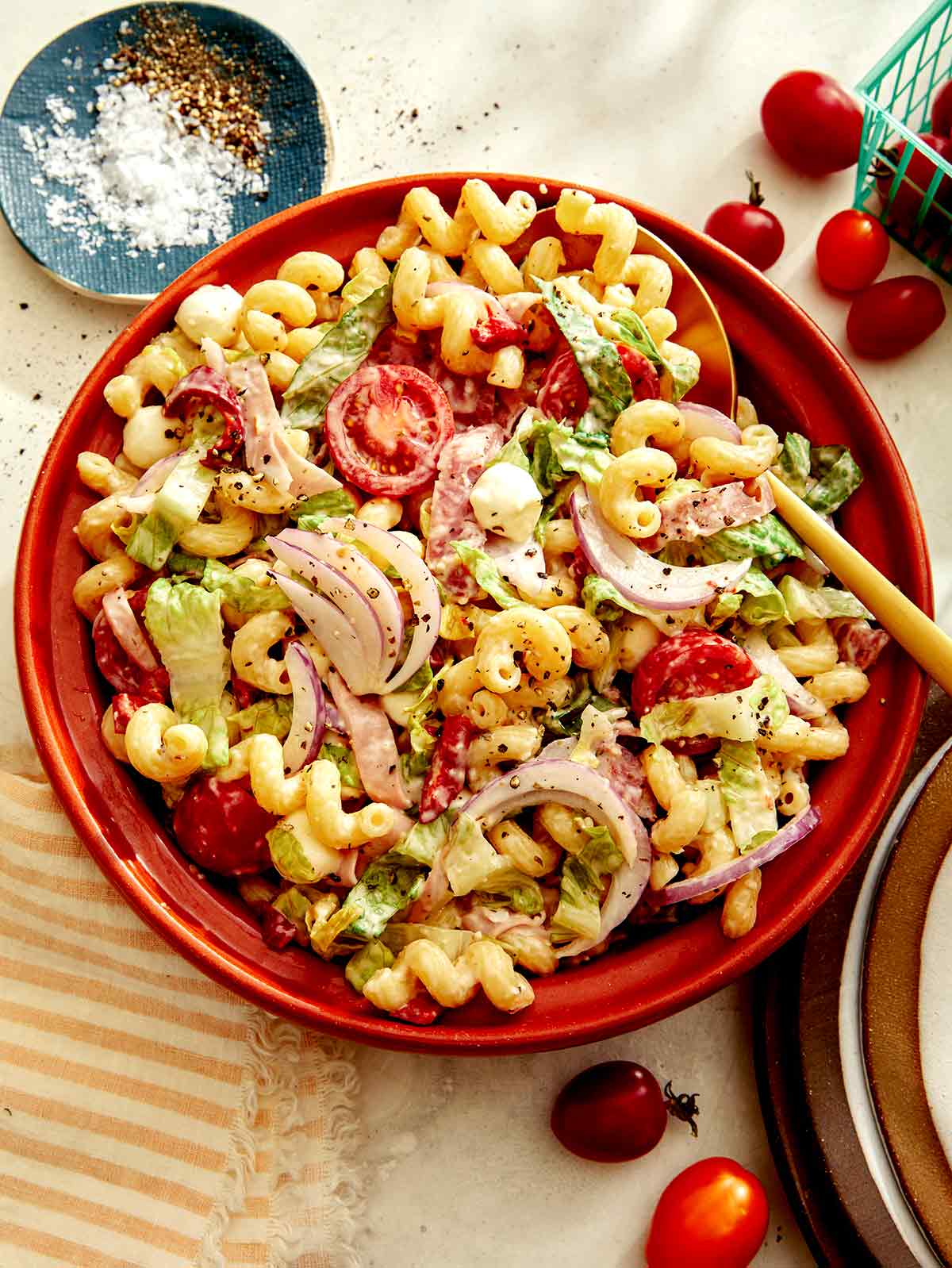 Grinder pasta salad in a bowl with ingredients on the side. 