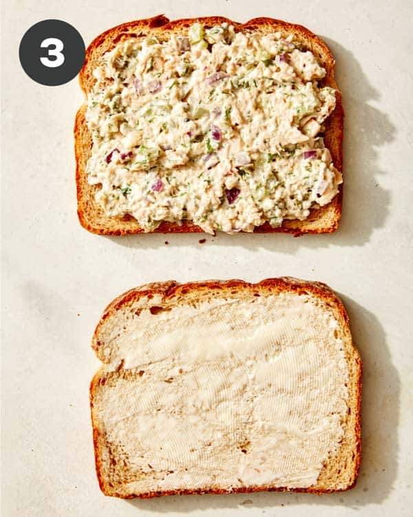 Tuna salad spread on a piece of bread for tuna melt. 